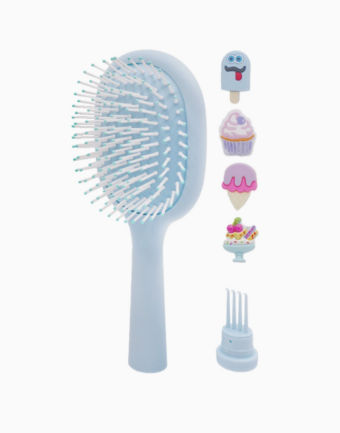 Blue hairbrush with detachable comb on a white background
