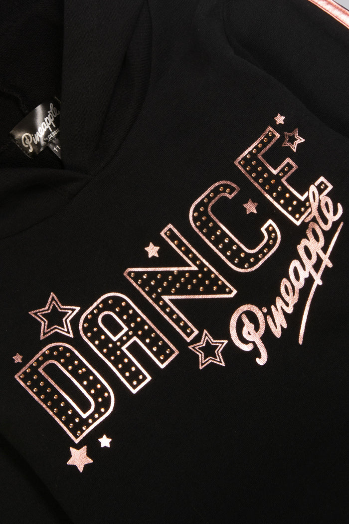 Detail shot of chest print of black hoodie featuring diamantés, stars, and Pineapple Dance Studios logo