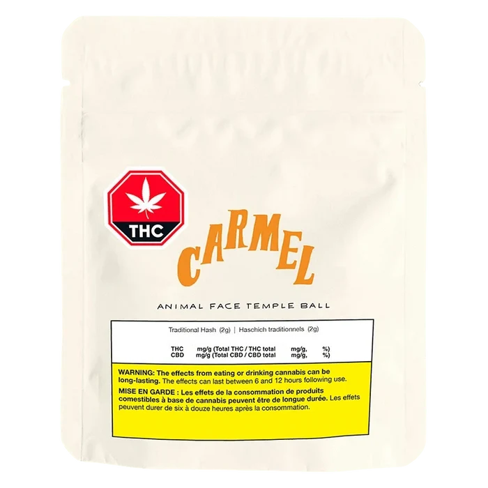 Front-facing pouch shot of a white Carmel Animal Face Temple Ball bag with a red THC badge and yellow warning panel.