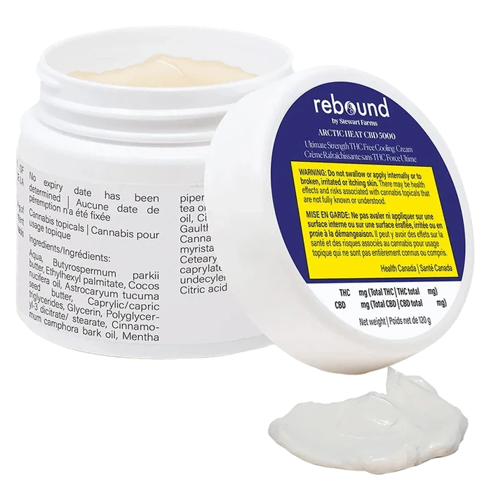 White jar of Arctic Heat Cbd 5000 Cooling Cream shown open at a three-quarter angle with the lid propped forward and a dollop of cream in front.