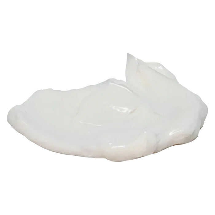 Close-up of a glossy white cream dollop on a plain background representing Arctic Heat Cbd 5000 Cooling Cream.