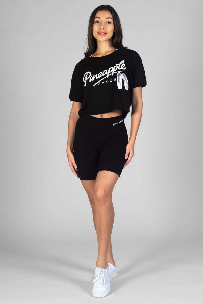 Woman wearing cropped black Ballet Slouchy T-Shirt and black Cycling Shorts