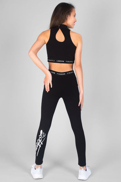 Girl wearing black Barbarella Crop Top and black Mesh Crop Leggings with logo