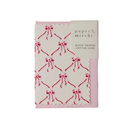 Block printed cotton greeting card with red bow pattern on a white background, branded 'Paper Mirchi'.