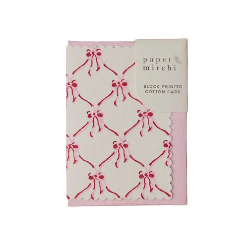 Block printed cotton greeting card with red bow pattern on a white background, branded 'Paper Mirchi'.