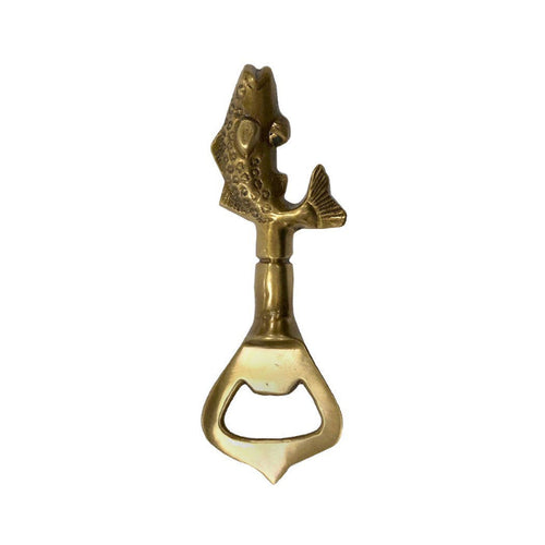Brass bottle opener with fish design on a white background