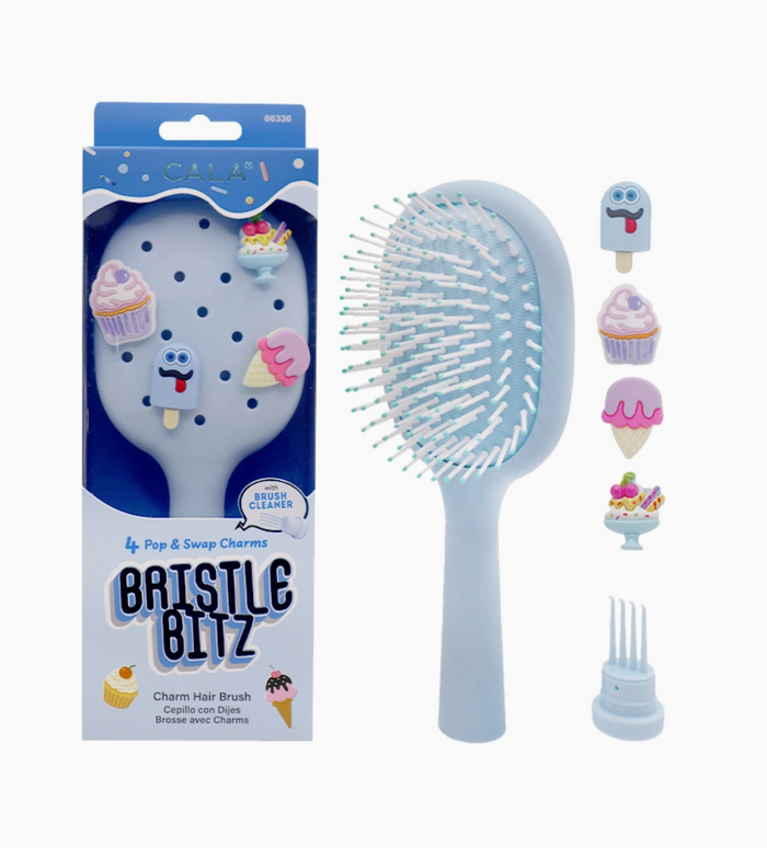 Bristle Bitz hairbrush with packaging and additional charms on a white background