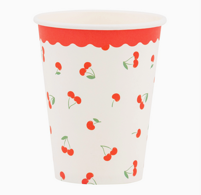 Paper cup with red cherry pattern on a white background