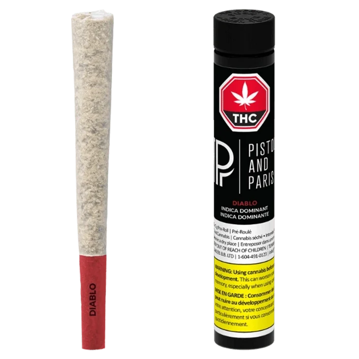 Studio-lit front view of a Diablo PR 1 x 1 g pre-roll with red paper tip beside its black Piston and Paris tube.