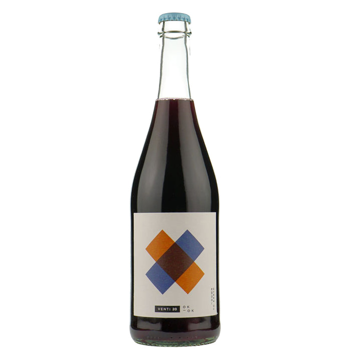 Wine bottle with dark red glass, blue foil cap, diamond-pattern label in blue and orange