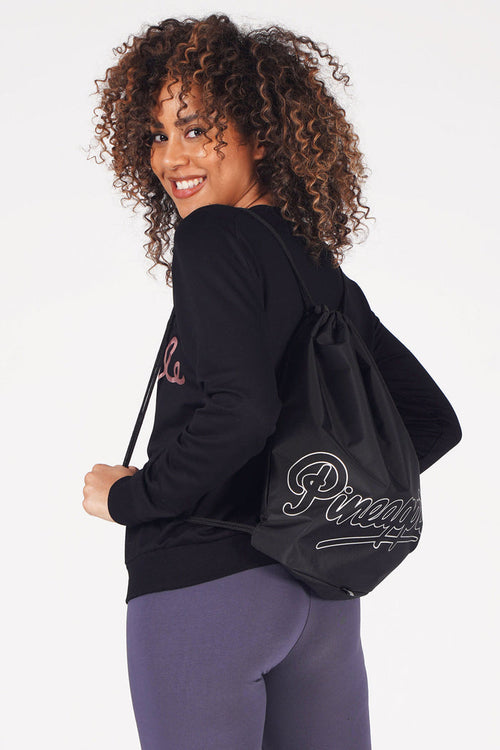 Woman carrying Pineapple Black Drawstring Bag
