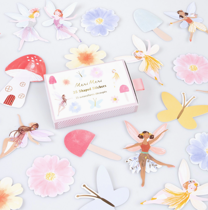 Shaped stickers including fairies, flowers, and mushrooms on a light gray background.