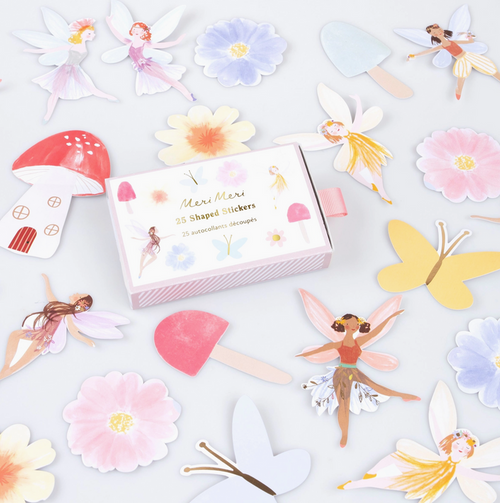Shaped stickers including fairies, flowers, and mushrooms on a light gray background.