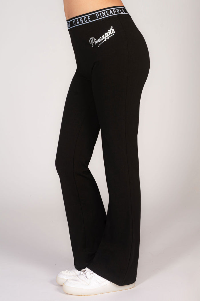 Girls' black flared leggings with Pineapple silver foil logo on hip