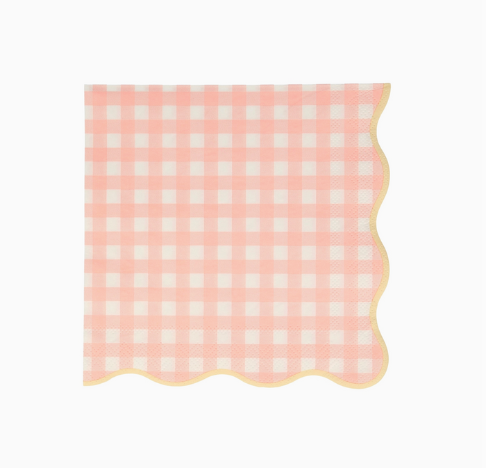 Pink and white checkered napkin with scalloped edge on a white background