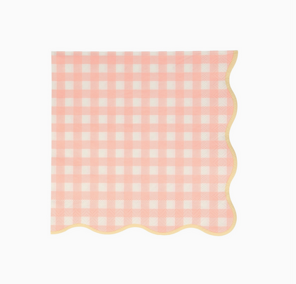 Pink and white checkered napkin with scalloped edge on a white background