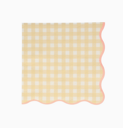 Yellow and white checkered napkin with scalloped edge on a white background