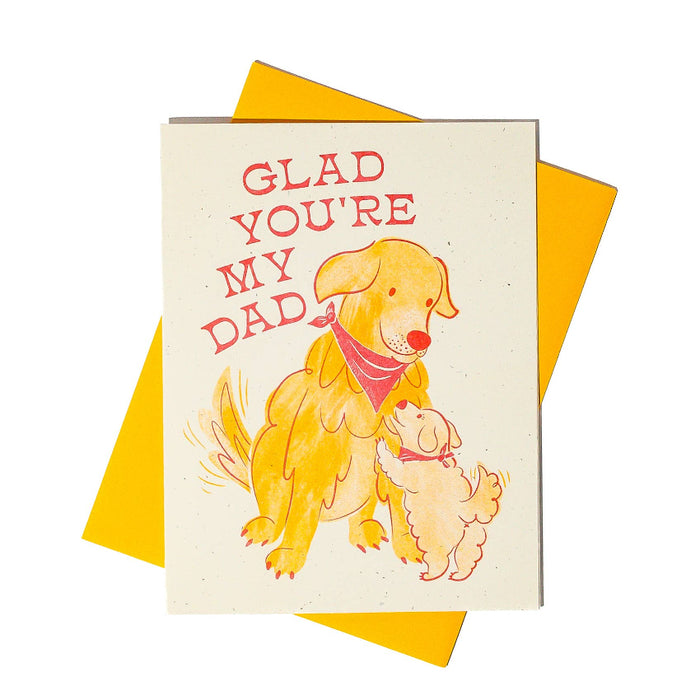 Greeting card with a dog illustration and 'Glad You're My Dad' text on a yellow envelope.