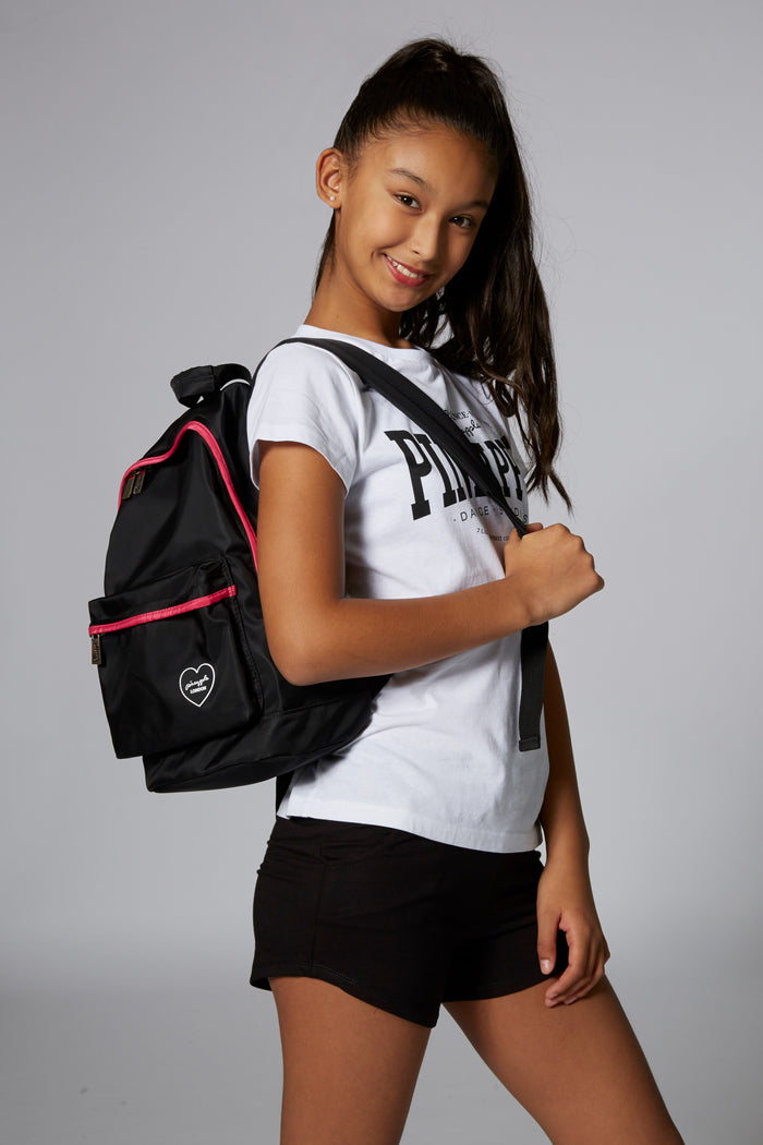 Girl carrying Pineapple Dance Black Heart Badge Backpack
