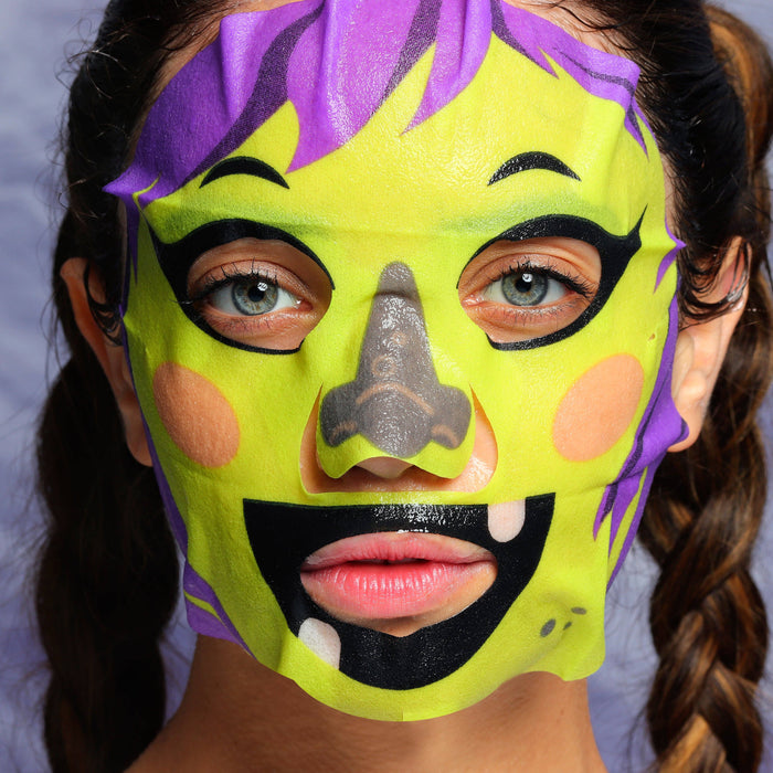 Person wearing a colorful mask with purple, yellow, and black design on a light gray background