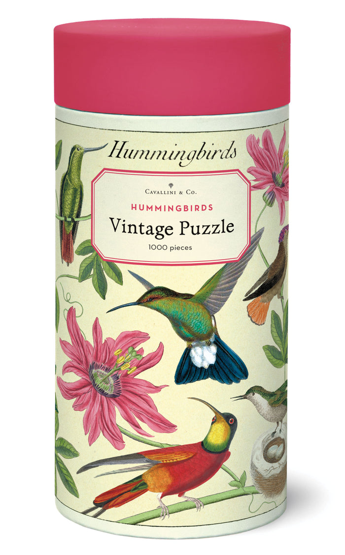 Cylindrical puzzle box with hummingbird design and pink lid.