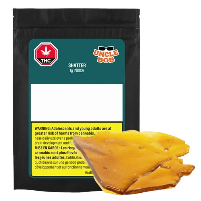 Front view of the Uncle Bob Indica Shatter 1 g package with a glossy amber-colored shatter piece resting in front.