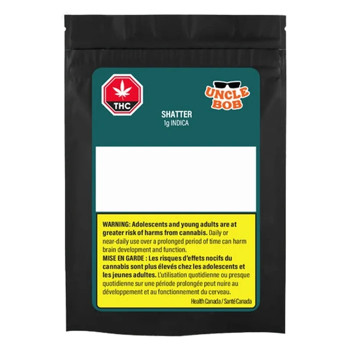 Front-facing black pouch labeled "Uncle Bob Indica Shatter" with teal header, empty white info panel and a yellow bilingual health warning block.