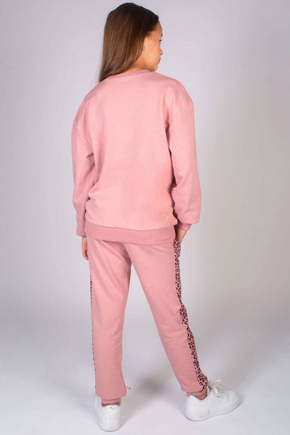 Pale pink sweater for girls paired with pale pink joggers to create a comfortable kids' outfit for travel and everyday