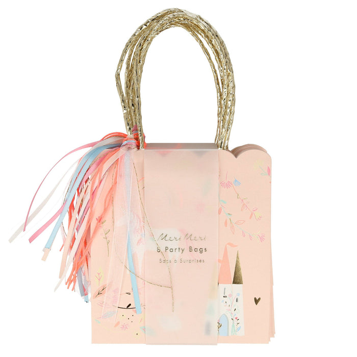 Pink party bag with decorative ribbons and straw handle on a white background