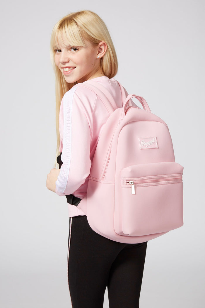 Girl carrying Pineapple Dance Pink Neoprene Backpack