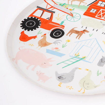 A close-up of a colorful paper dinner plate with an illustration of a farmyard scene, including a red barn, tractor, and various farm animals.