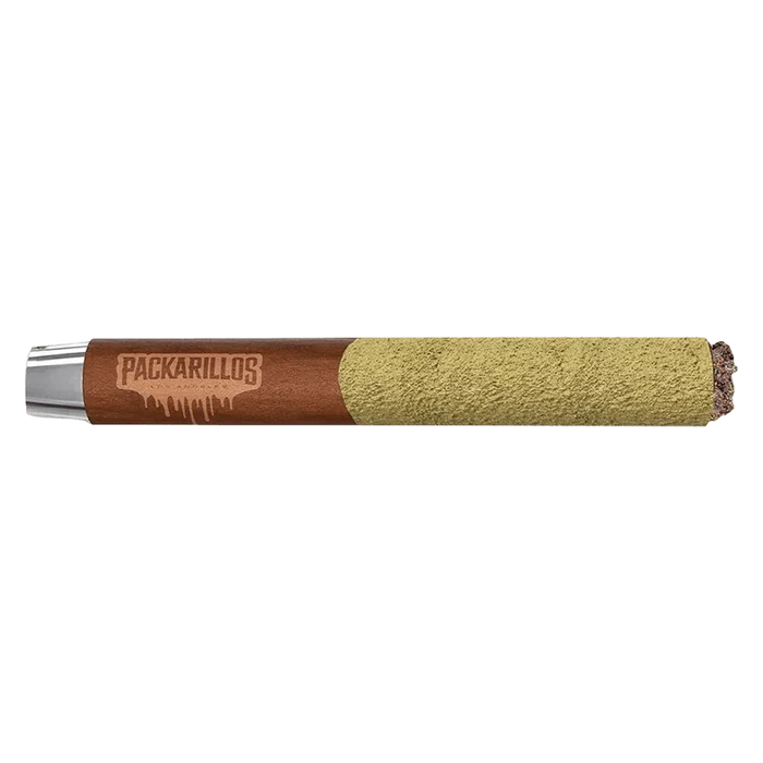Side-on studio shot of a Packarillos Purple Zaza Infused PR 1 x 1 g blunt showing the brown branded paper and a heavy greenish kief coating on the rolled end.