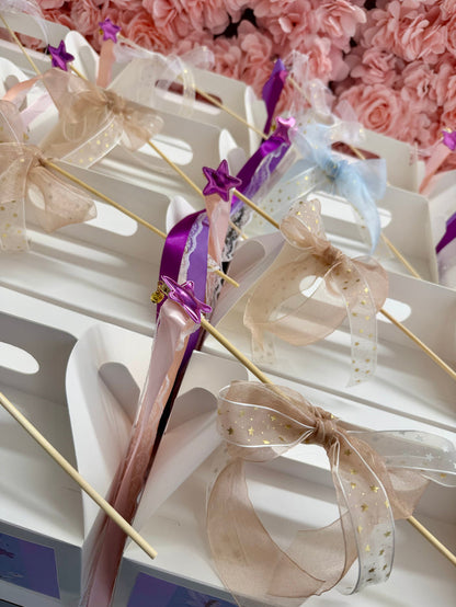 Decorative items with ribbons and bows on a white surface against a floral background