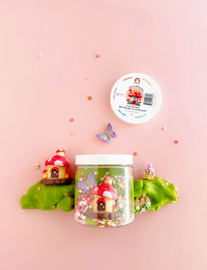 Decorative jar with fairy house design on a pink background