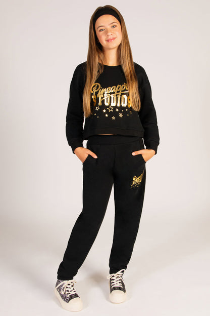 The ultimate festive teen outfit featuring a black sweat top and matching cuff joggers with gold foil detail.