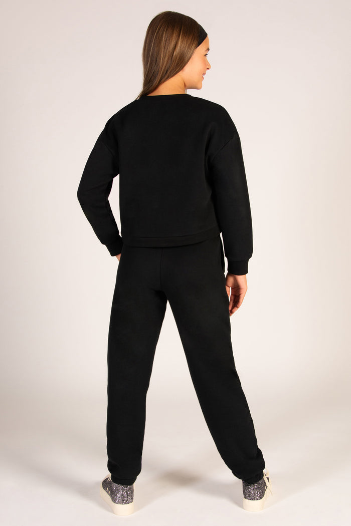 Black sweatpants for kids with two side pockets and an elasticated waistband.