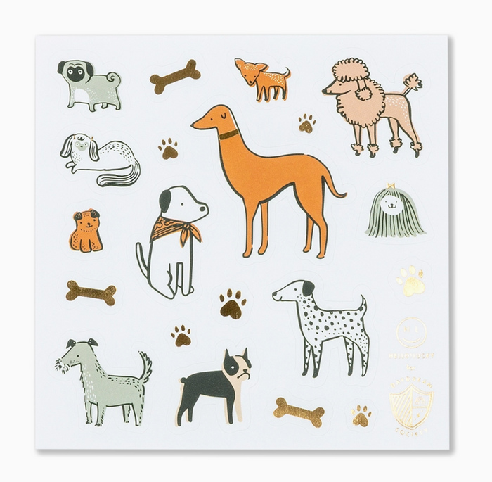 A square white sticker sheet featuring various hand-drawn dog illustrations in orange, black, white, and gray, along with brown bones and paw prints, and a small gold foil seal at the bottom right.