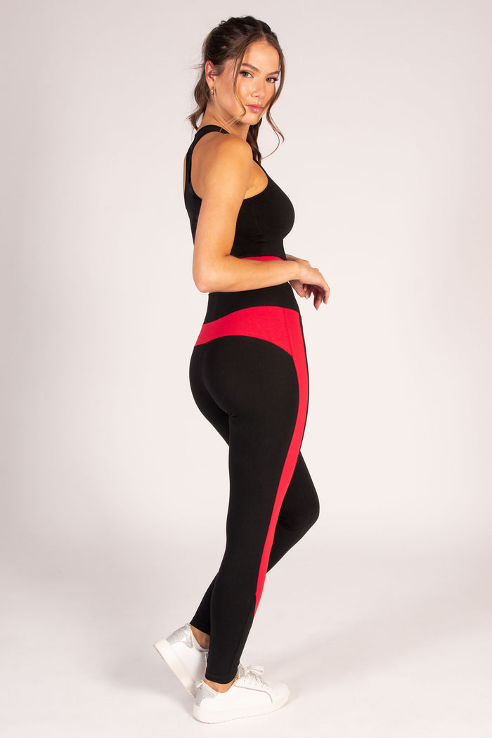 Kianna Louise wearing black leggings with red panels along the legs, designed by Pineapple.