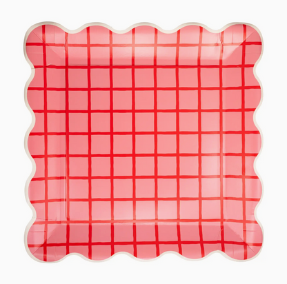 Pink and red checkered plate with scalloped edge on a white background
