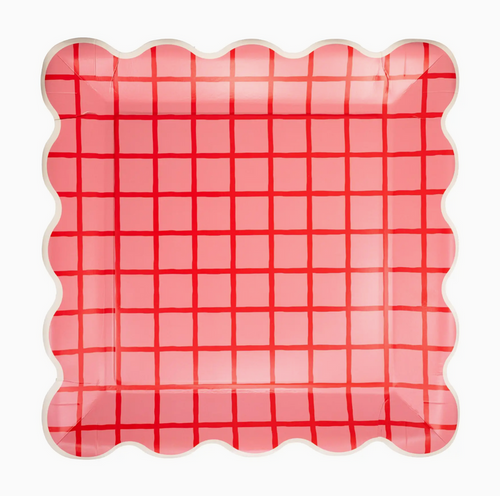 Pink and red checkered plate with scalloped edge on a white background