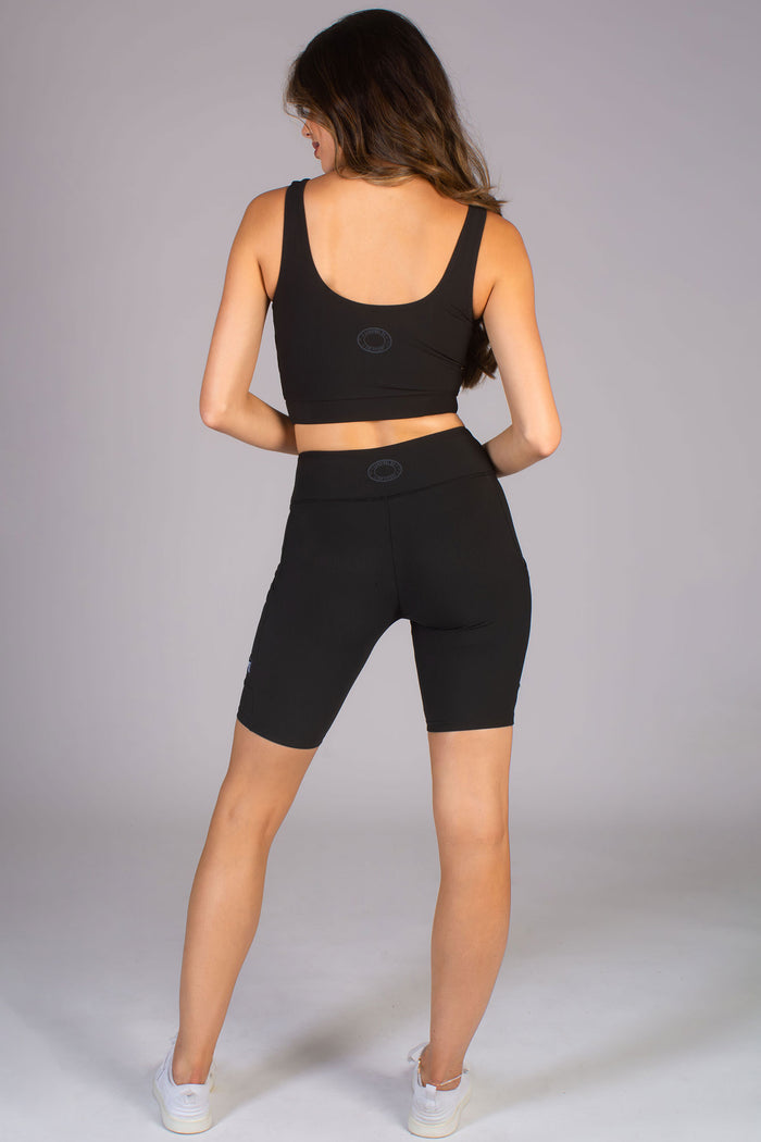 Women's black seam free yoga set with cycling shorts and matching midi crop top