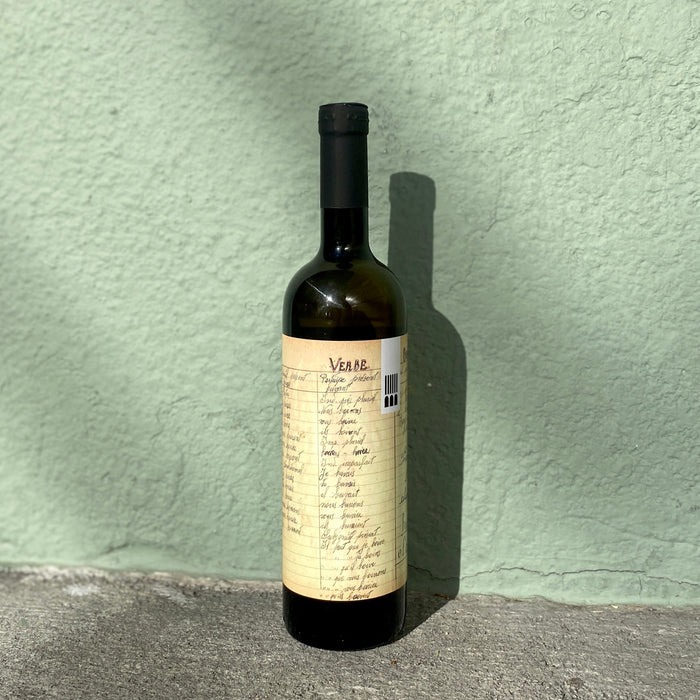 White wine bottle with cream label, barcode, and dark bottle neck
