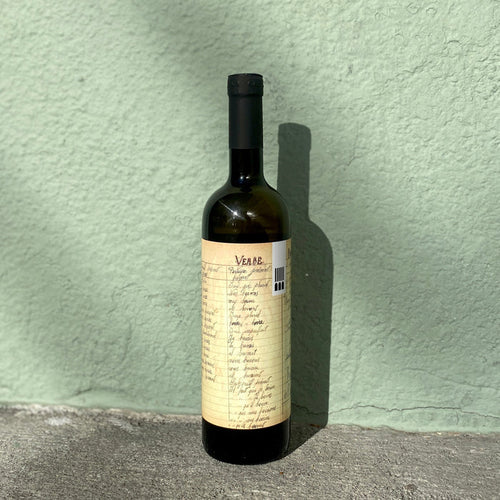 White wine bottle with cream label, barcode, and dark bottle neck