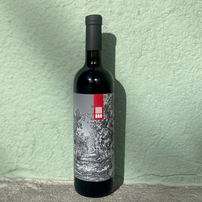 2020 red wine bottle with silver foil label and barcode stripe
