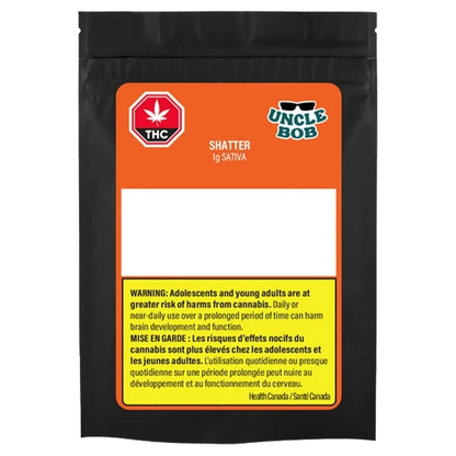 Front-facing shot of the black pouch packaging labeled "Uncle Bob Sativa Shatter" with an orange label, THC symbol, and yellow warning panel.