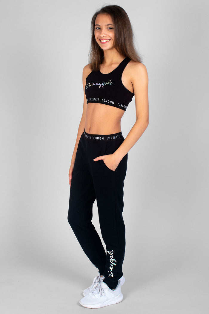 Girl wearing logo black Script Joggers and matching black Srip Crop Top
