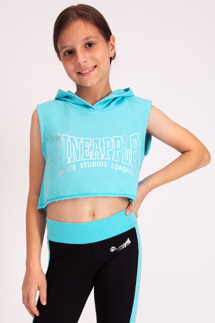 Girls' turquoise sleeveless hoodie in cropped fit featuring a Pineapple Dance Studios London chest print.
