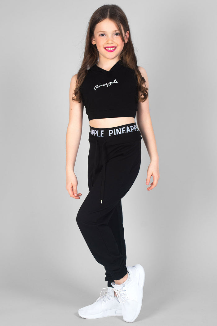 Girl wearing black Sleeveless Hoodie with white logo and black Double Trackpants