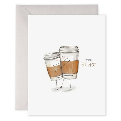Illustrated greeting card featuring two anthropomorphized coffee cups hugging with the phrase "you're so hot," in gold-foiled writing is the E. Frances So Hot Card.