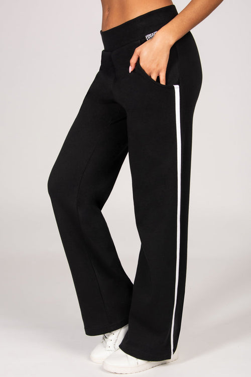 Black trousers with a white stripe on the side on a plain background